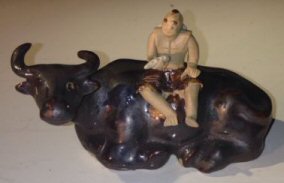 Ceramic Figure Man Sitting On Sitting Buffalo Large - Culture Kraze Marketplace.com