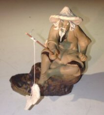 Ceramic Figurine  Mud Man Sitting On A Rock Fishing - Culture Kraze Marketplace.com
