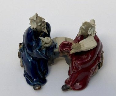 Ceramic Figurine Two Men Sitting On A Bench Holding Fan & Pipe- 2.0" Color: Red & Blue - Culture Kraze Marketplace.com