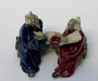 Ceramic Figurine Two Men Sitting On A Bench Holding Fan & Pipe- 2.0" Color: Red & Blue - Culture Kraze Marketplace.com