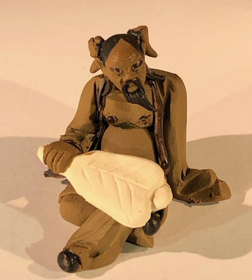 Ceramic Figurine  Mud Man Holding a Fan Sitting Down - 2" - Culture Kraze Marketplace.com