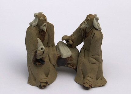 Ceramic Figurine Two Mud Men Sitting On A Bench Holding Pipe 2" - Culture Kraze Marketplace.com