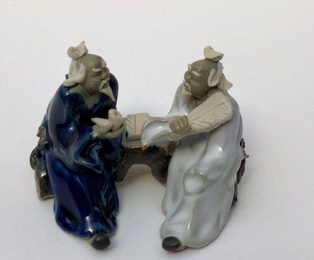 Ceramic Figurine Two Men Sitting On A Bench Holding Fan & Pipe- 2.25" Color: Blue & White - Culture Kraze Marketplace.com